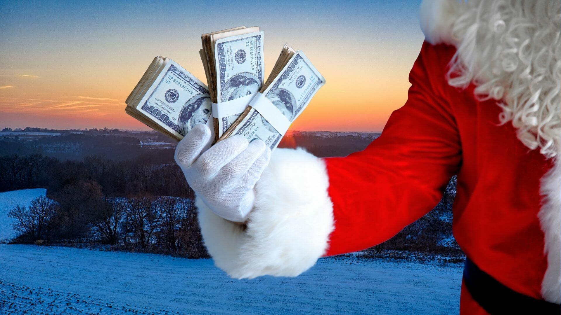 Santa holding cash overlooking snowy Michigan countryside, representing year-end land investment and buying Michigan land during the holidays
